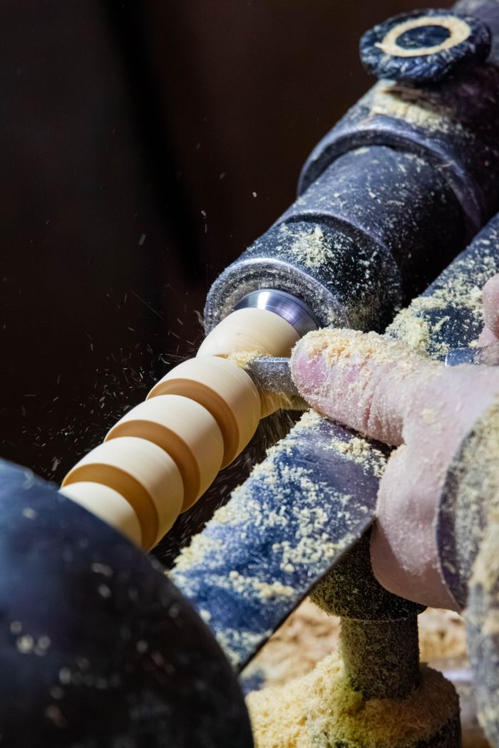 contact-img Close-up of woodturning on a lathe, showcasing traditional craftsmanship in Fes, Morocco.