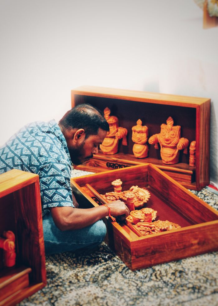 services-02 Skilled artisan meticulously crafting traditional wooden sculptures in Bhubaneswar, India.